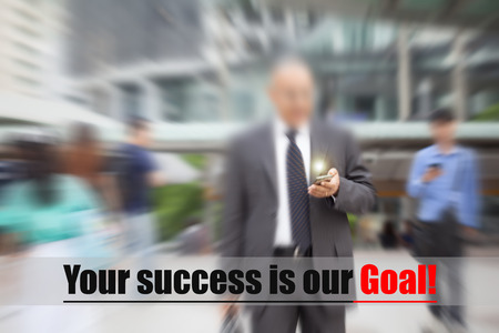 motion blur suit and tie businessman hand on mobile phone walking to workの写真素材