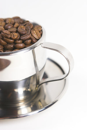 Coffee beans in a metal mugの写真素材