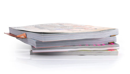 Stack of glossy magazines on a white background.の写真素材