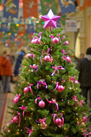 Christmas tree with pink ornamentation and star.の写真素材