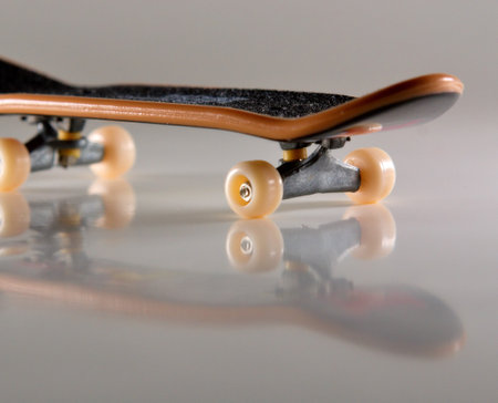 Macro of fingerboard on light background with reflectionの写真素材