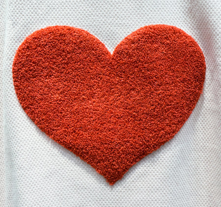 Cloth background with red heartの写真素材