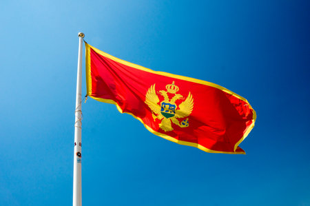 A montenegrin flag waves in the windの写真素材