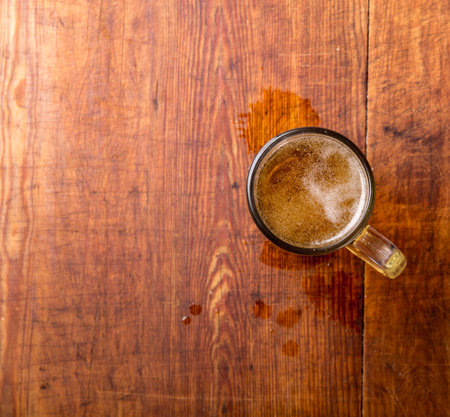 Glass of beer on the wooden grunge table.の写真素材