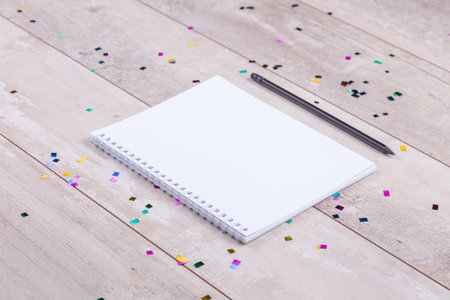 Blank notepad and pencil on the wooden table. View from aboveの写真素材