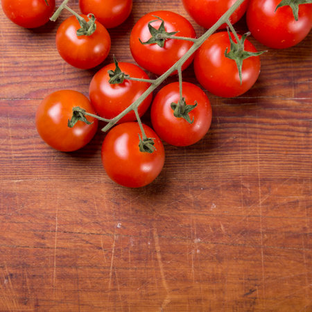 Tomato branch on vintage wood table.の写真素材