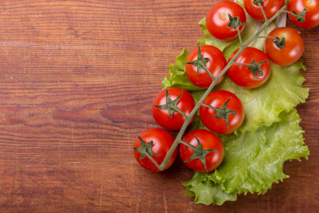 Tomato branch on vintage wood table.の写真素材
