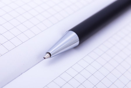 close-up of ball point pen over paper.