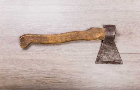 Old and dirty axe on wood background.の写真素材