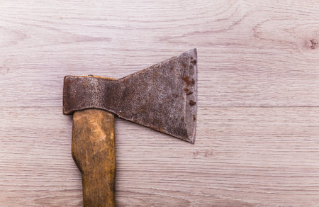 Old and dirty axe on wood background.の写真素材