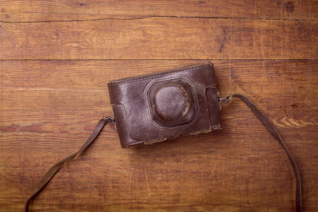 wooden background with retro still camera in caseの写真素材