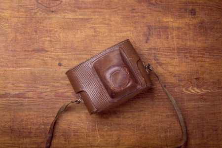 wooden background with retro still camera in caseの写真素材