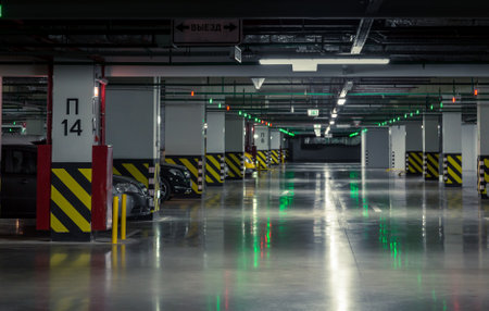 Parking garage, underground interior with a few parked cars.の写真素材