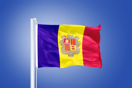 Flag of Andorra flying against a blue sky.の写真素材