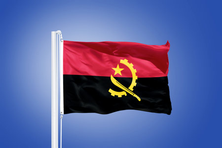 Flag of Angola flying against a blue sky.の写真素材