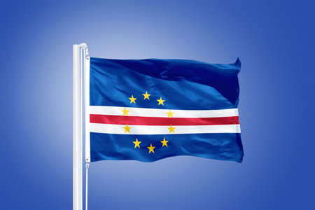 Flag of Cape Verde flying against a blue sky.の写真素材