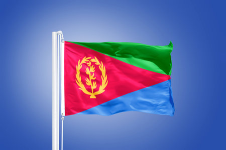 Flag of Eritrea flying against a blue sky.の写真素材