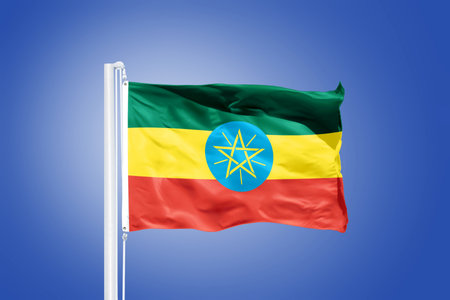 Flag of Ethiopia flying against a blue sky.の写真素材