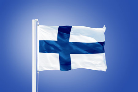 Flag of Finland flying against a blue sky.の写真素材