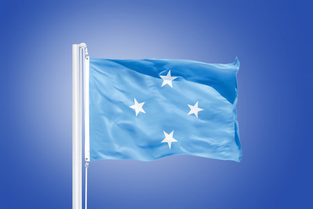 Flag Federated States of Micronesia flying against a blue sky.の写真素材