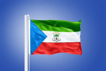 Flag of Equatorial Guinea flying against a blue sky.の写真素材