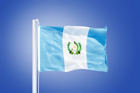 Flag of Guatemala flying against a blue sky.の写真素材