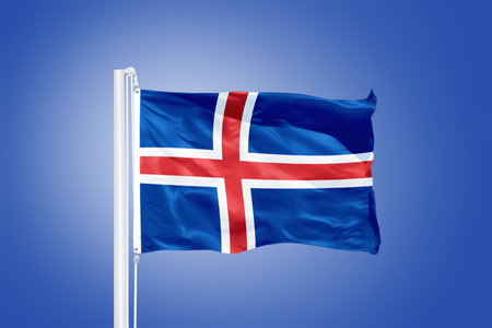 Flag of Iceland flying against a blue sky.の写真素材