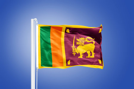 Flag of Sri Lanka flying against a blue sky.の写真素材