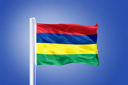 Flag of Mauritius flying against a blue sky.の写真素材