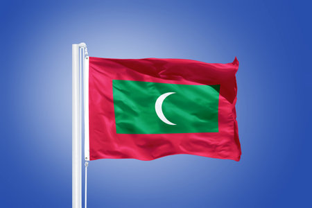 Flag of Maldives flying against a blue sky.の写真素材