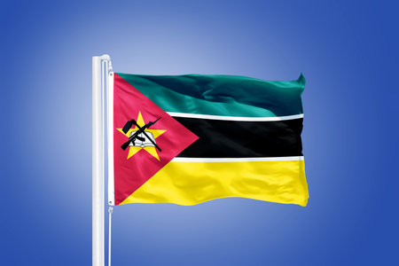 Flag of Mozambique flying against a blue sky.の写真素材