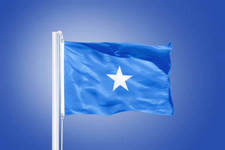 Flag of Somalia flying against a blue sky.の写真素材
