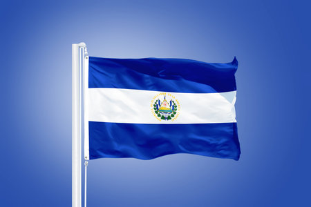 Flag of El Salvador flying against a blue sky.の写真素材