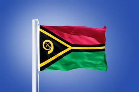 Flag of Vanuatu flying against a blue sky.の写真素材