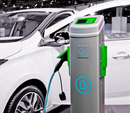 Plug-in electric car being charged.の写真素材