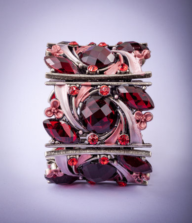 Beautiful bracelet with precious stones on color background.の写真素材