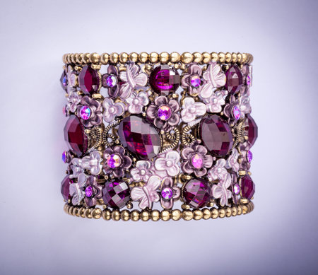 Beautiful bracelet with precious stones on color background.の写真素材