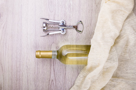 Wine bottle with corkscrew on wooden background.の写真素材