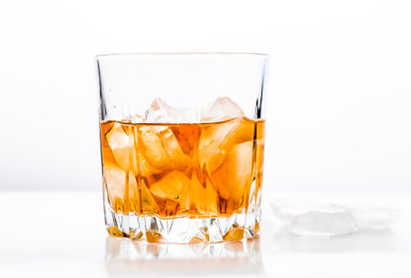 Glass of cold whiskey on wooden surface.の写真素材