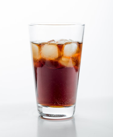 Cola glass with ice cubes on a white background.