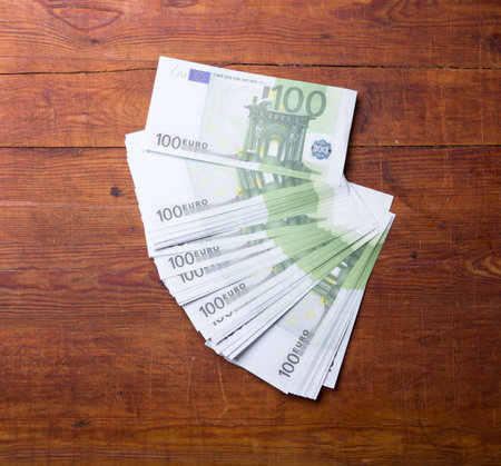 Close-up of 100 Euro banknotes on wood background.の写真素材