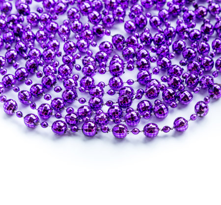Purple beads garland isolated on white.の写真素材