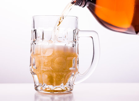 Beer is pouring into the glass.の写真素材