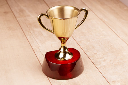 Golden trophy on wood background.の写真素材