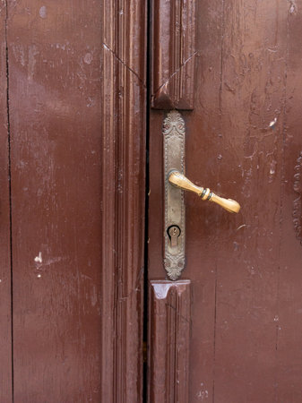 door handle. Brown wooden door. The door handle is aluminum.の写真素材