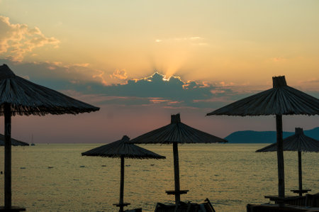 Parasol at the beach at sunset.の写真素材