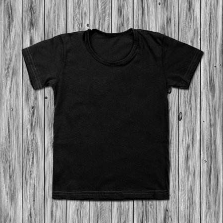 Black blank t-shirt on wood background.の写真素材