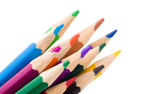 Many different colored pencils on white background.