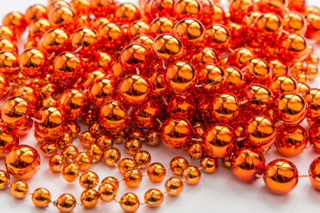 Gold beads close-up xmas background.の写真素材