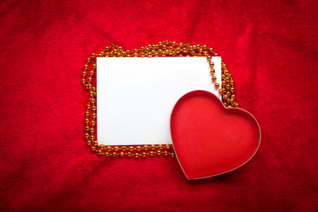 heart with a blank card on red background.の写真素材
